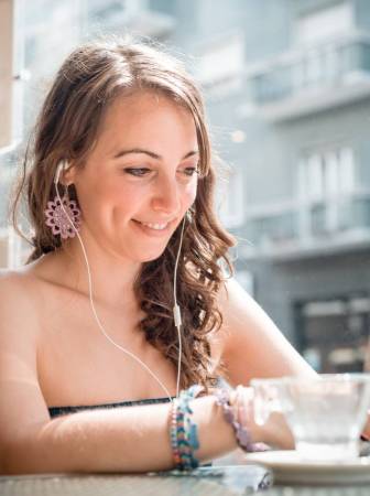 graphicstock-young-beautiful-woman-listening-to-music-at-the-coffee_bekrhf-gb